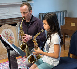 saxophone student and teacher performing together