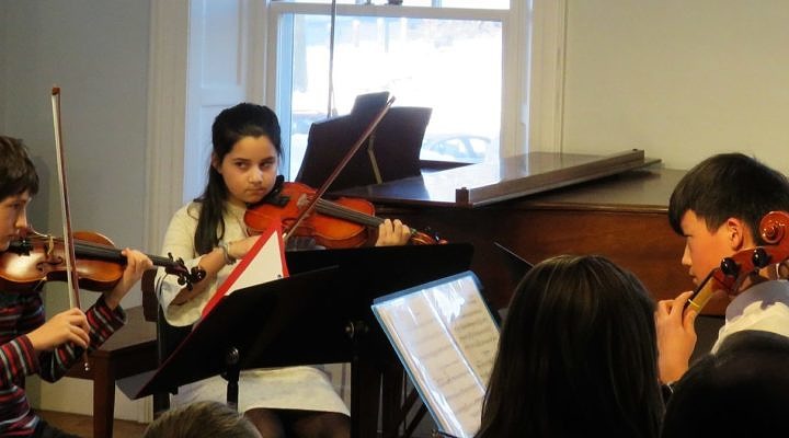 young chamber ensemble performing on violin and cello