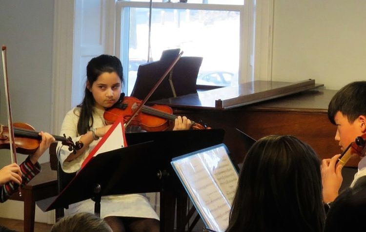 young chamber ensemble performing on violin and cello