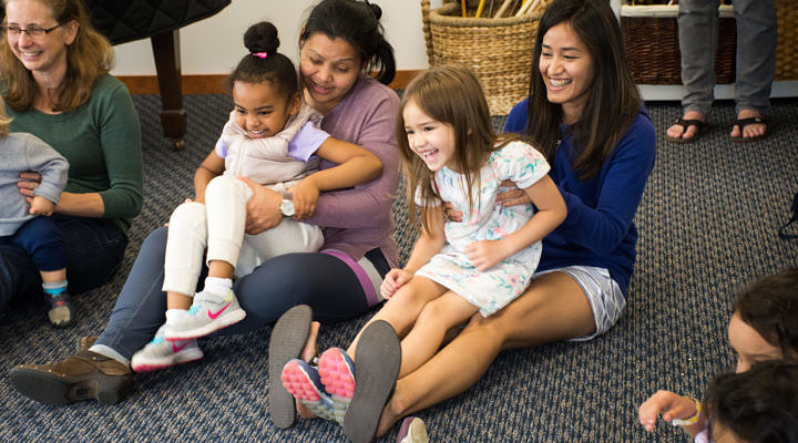 A family enjoys music class with young children.