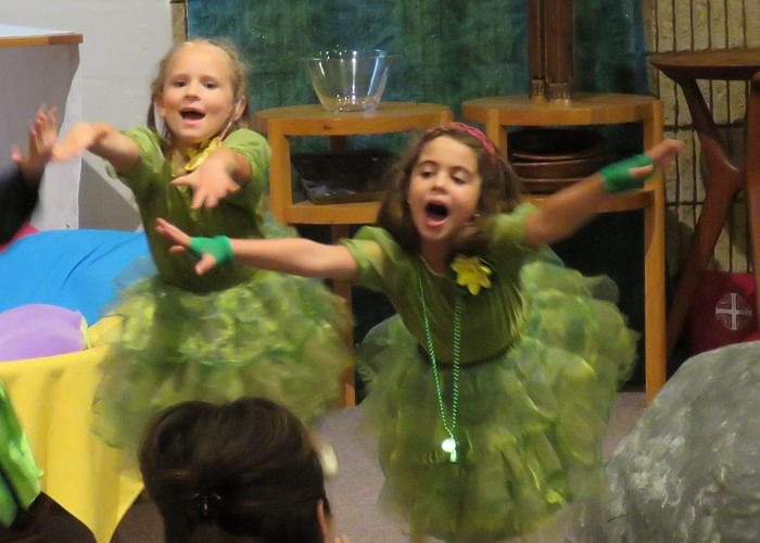 Two girls sing in costume during Music and Drama summer camp