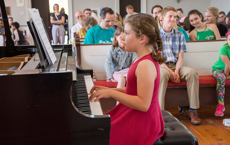 child playing the piano at a recital