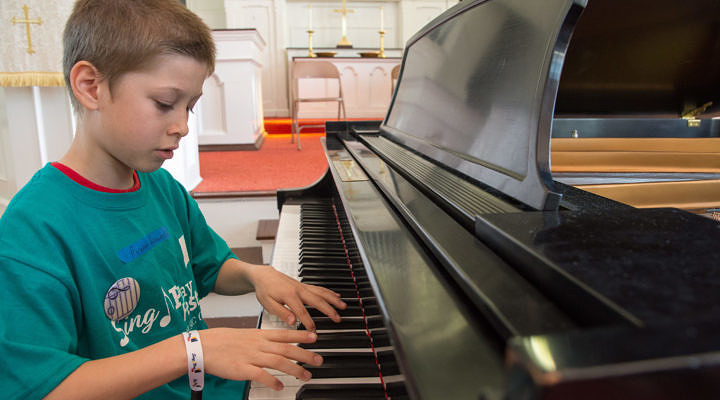 Young student performing on piano
