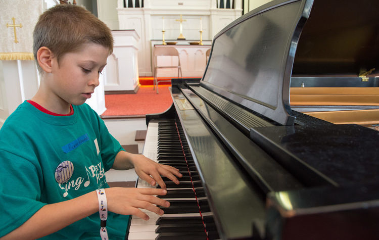 Young student performing on piano