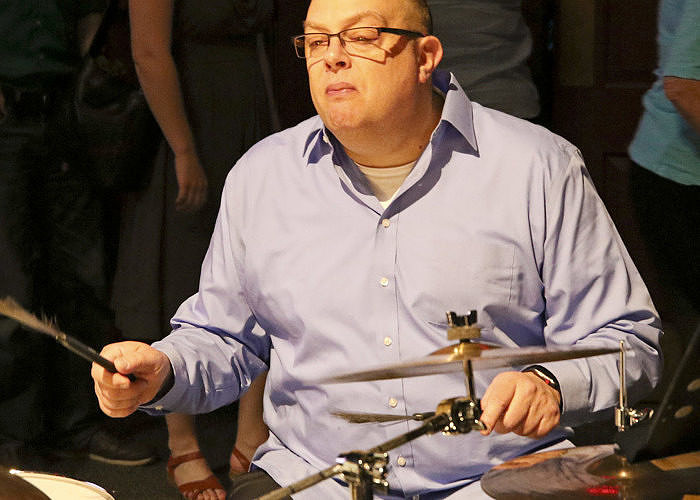 Faculty Tim Cohen performs on drum kit