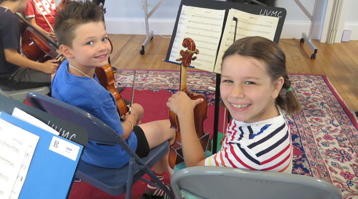 Summer string camp students play together.