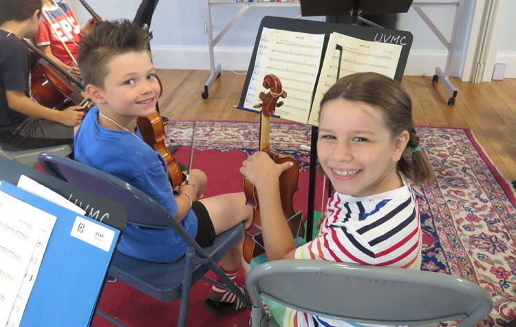 Summer string camp students play together.
