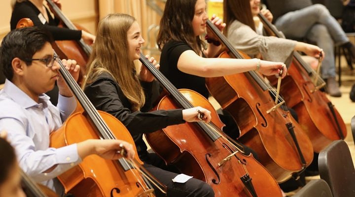 teen cellist performing ensemble