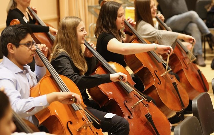 teen cellist performing ensemble