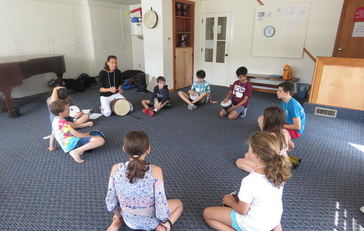 circle of kids drumming