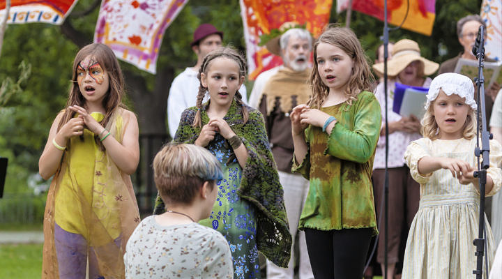 two girls in costume singing