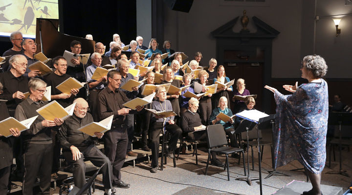 Chorus singing with conductor
