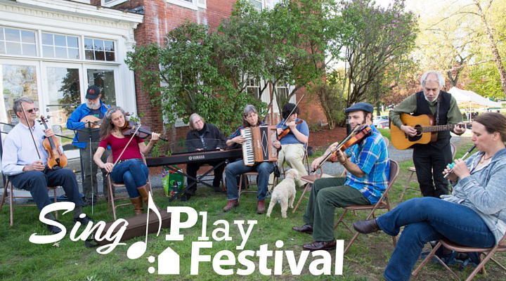 folks sitting outside playing fiddle tunes on various instruments
