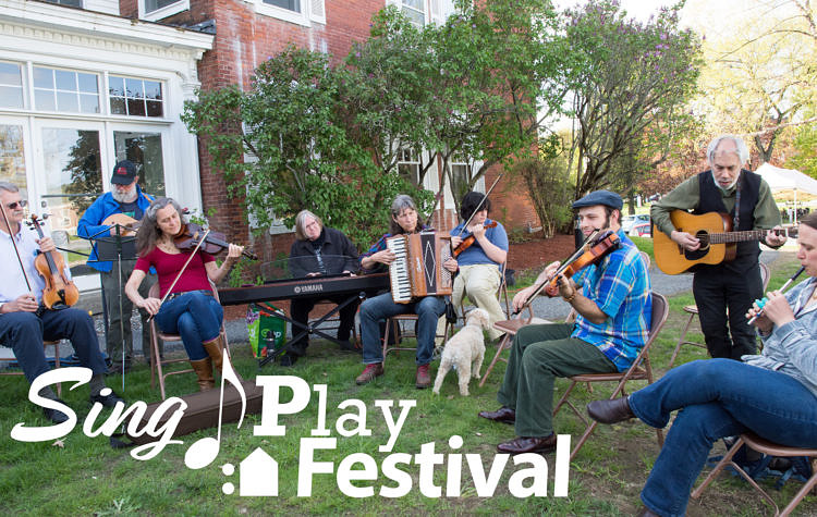 folks sitting outside playing fiddle tunes on various instruments