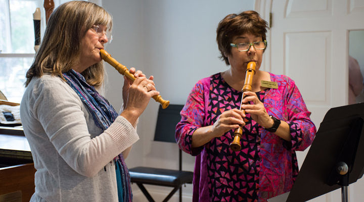 Two women playing recorder