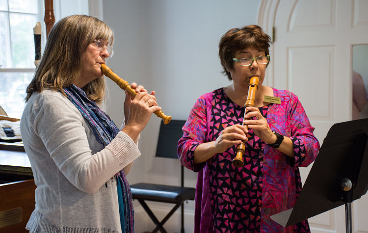 Two women playing recorder