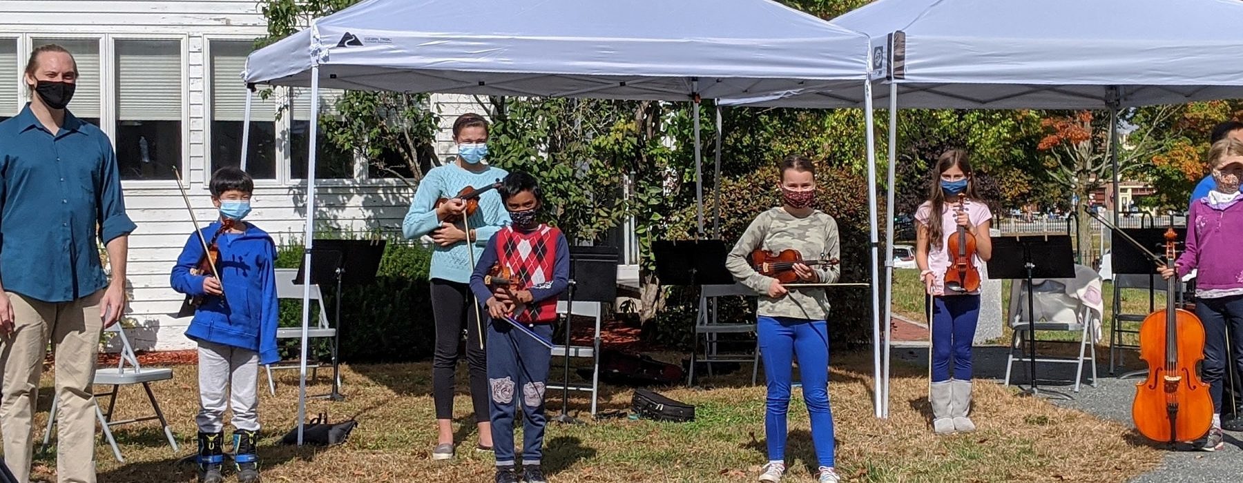kids with violins and mask
