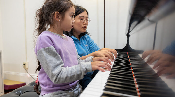 teacher with student at keyboard