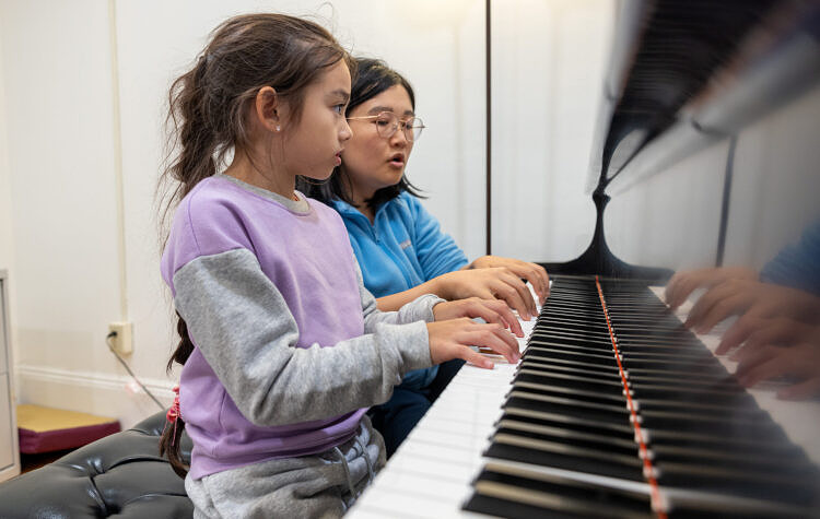 teacher with student at keyboard