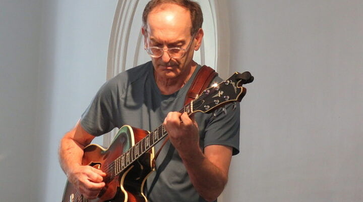 UVMC instructor Draa Hobbs playing guitar