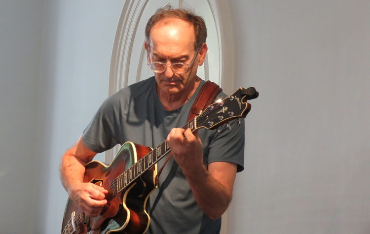 UVMC instructor Draa Hobbs playing guitar